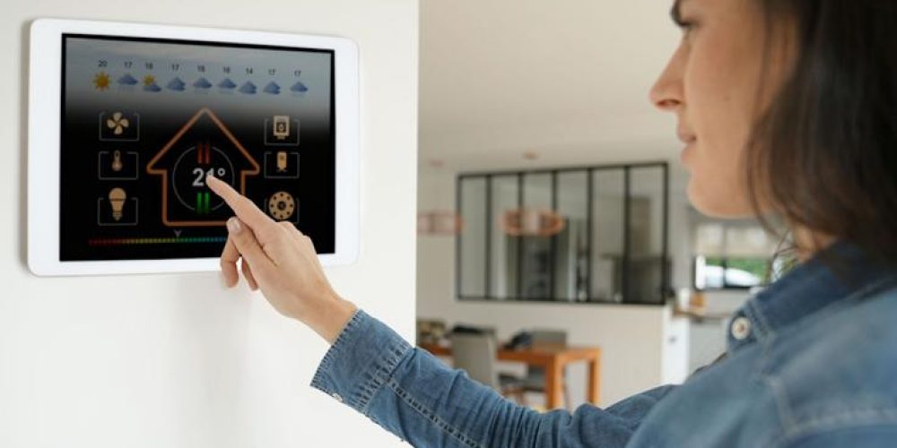Woman,Using,Smart,Wall,Home,Control,System Woman,Using,Smart,Wall,Home,Control,System